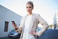 Stern elegant businesswoman holding smartphone Royalty Free Stock Photo