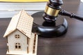 A stern judge, gavel in hand, stands before a wooden table in a courtroom. Justice is being served as an eviction due to unpaid Royalty Free Stock Photo