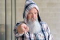 Stern man wearing a hooded top pointing Royalty Free Stock Photo