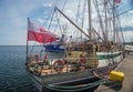 Stern of old training sailship with flag in Gdynia Royalty Free Stock Photo