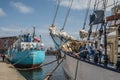 Stern of a small blue cargo ship mooring in harbor in the Old Town of Gdansk under clouds Royalty Free Stock Photo