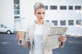 Stern stylish businesswoman reading newspaper Royalty Free Stock Photo