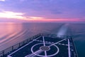 Stern of the warship and laminar flow of the water created by its propel with motion blur effect before sunset