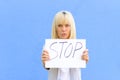 Stern young woman holding up a stop sign Royalty Free Stock Photo
