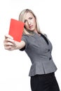 Stern young woman showing a red card