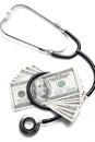 Stethoscope and 100 dollar bills Royalty Free Stock Photo