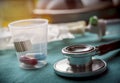 Stethoscope along with doses of medicine in a hospital, conceptual image