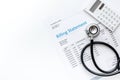 Stethoscope, billing statement for doctor`s work white background top view space for text