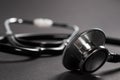 Stethoscope on black background with space for text - health concept. Medical conceptual