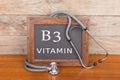 stethoscope and blackboard with text & x22;Vitamin B3& x22; on wooden background Royalty Free Stock Photo