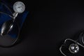 Stethoscope and blood pressure meter monitor isolated on black background. Royalty Free Stock Photo