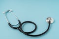 A stethoscope on blue background. Copy space