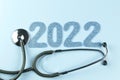 Stethoscope with 2022 blue number on blue background.