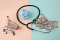 Stethoscope,blue piggy bank and money - a business concept in medicine Royalty Free Stock Photo