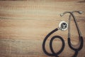 Stethoscope with blue tube on wood table top view with copy space. health and medical concept. vintage tone.