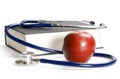 Stethoscope, book and apple Royalty Free Stock Photo