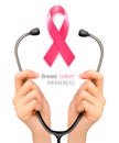 Stethoscope with a breast cancer awareness ribbon. Royalty Free Stock Photo