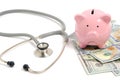 Stethoscope, bunch dollars and piggy bank on white background, concept expensive medicine