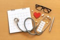 Stethoscope and calendar on wooden table, schedule to check up healthy concept Royalty Free Stock Photo