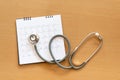 Stethoscope and calendar on wooden table, schedule to check up healthy concept Royalty Free Stock Photo