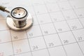 Stethoscope and calendar on wooden table, schedule to check up healthy concept Royalty Free Stock Photo