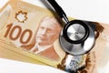 Stethoscope and Canadian dollar