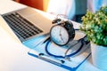 Stethoscope, clipboard, clock and laptop on doctor desk Royalty Free Stock Photo
