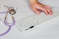 Stethoscope with clipboard and Laptop on desk,Doctor working in hospital writing a prescription, Royalty Free Stock Photo