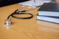 Stethoscope with clipboard and Laptop on desk Doctor working in