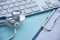 Stethoscope with clipboard and Laptop on desk,Doctor working in hospital writing a prescription. Healthcare and medical Royalty Free Stock Photo