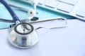 Stethoscope with clipboard and Laptop on desk,Doctor working in hospital writing a prescription. Healthcare and medical Royalty Free Stock Photo