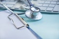 Stethoscope with clipboard and Laptop on desk,Doctor working in hospital writing a prescription. Healthcare and medical Royalty Free Stock Photo