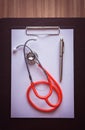 Stethoscope with clipboard and pen on desk Royalty Free Stock Photo