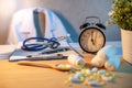 Stethoscope, clipboard and table clock on doctor desk Royalty Free Stock Photo