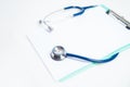 Stethoscope and clipboard on white background. Medical inspection concept.