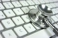 Stethoscope. Computer keyboard Royalty Free Stock Photo