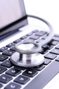 Stethoscope on computer keyboard with white background Royalty Free Stock Photo