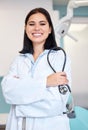 Stethoscope, crossed arms and portrait of woman dentist with confidence in her office at the clinic. Happy, medical and Royalty Free Stock Photo