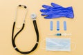 stethoscope crumpled gloves bandages syringe surgical gloves yellow background. High quality photo