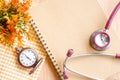 Stethoscope on Diary and vintage clock .