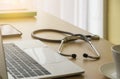 Stethoscope on Doctor desk with labtop, smartphone, file folder and coffee cup in doctor room, focus on stethoscope. Healthcare Royalty Free Stock Photo