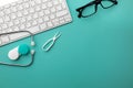 Stethoscope in doctors desk with notebook, pen, keyboard, mouse and pills