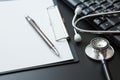 Stethoscope, Document Board, Keyboard computer, Notebook, Pen  on black background and copy space Royalty Free Stock Photo
