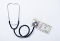 Stethoscope with dollar on white background, health insurance concept Royalty Free Stock Photo