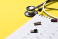 Stethoscope, drug and calendar on the yellow background, schedule to check up healthy concept