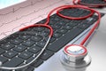 Stethoscope and ECG on laptop keyboard Royalty Free Stock Photo