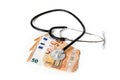 Stethoscope on euro money banknotes, healthcare costs or medical corruption concept isolated on a white background Royalty Free Stock Photo