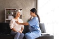 Stethoscope exam. Attractive cheerful asian female doctor listening to the elderly while using stethoscope