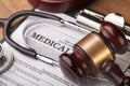 Wooden gavel and stethoscope, close-up view