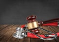 Wooden gavel and stethoscope on wooden table